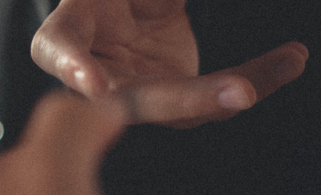 Two hands coming together as they reach for one another